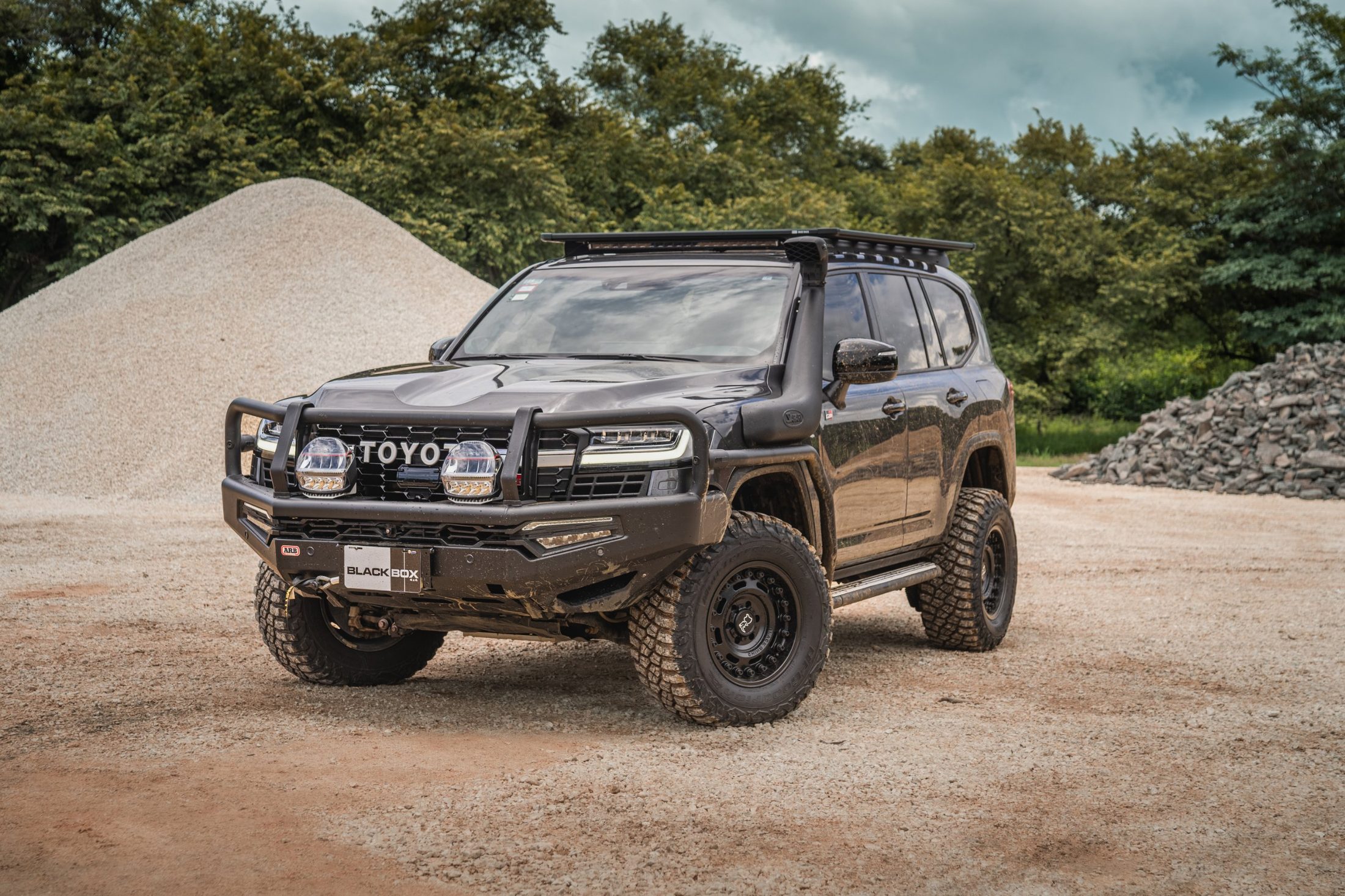 Black Toyota Land Cruiser 300 with ARB bull bar at a gravel quarry, photographed by Maxime Hugo