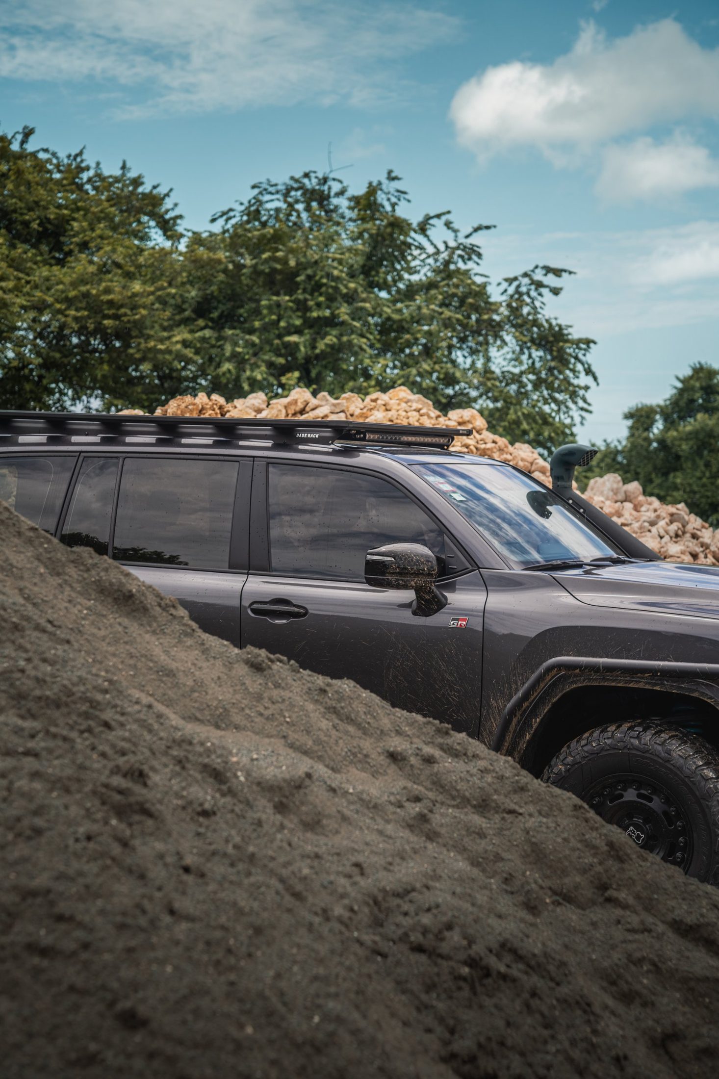 Toyota Land Cruiser 300 GR Sport behind a mound of sand, photographed by Maxime Hugo