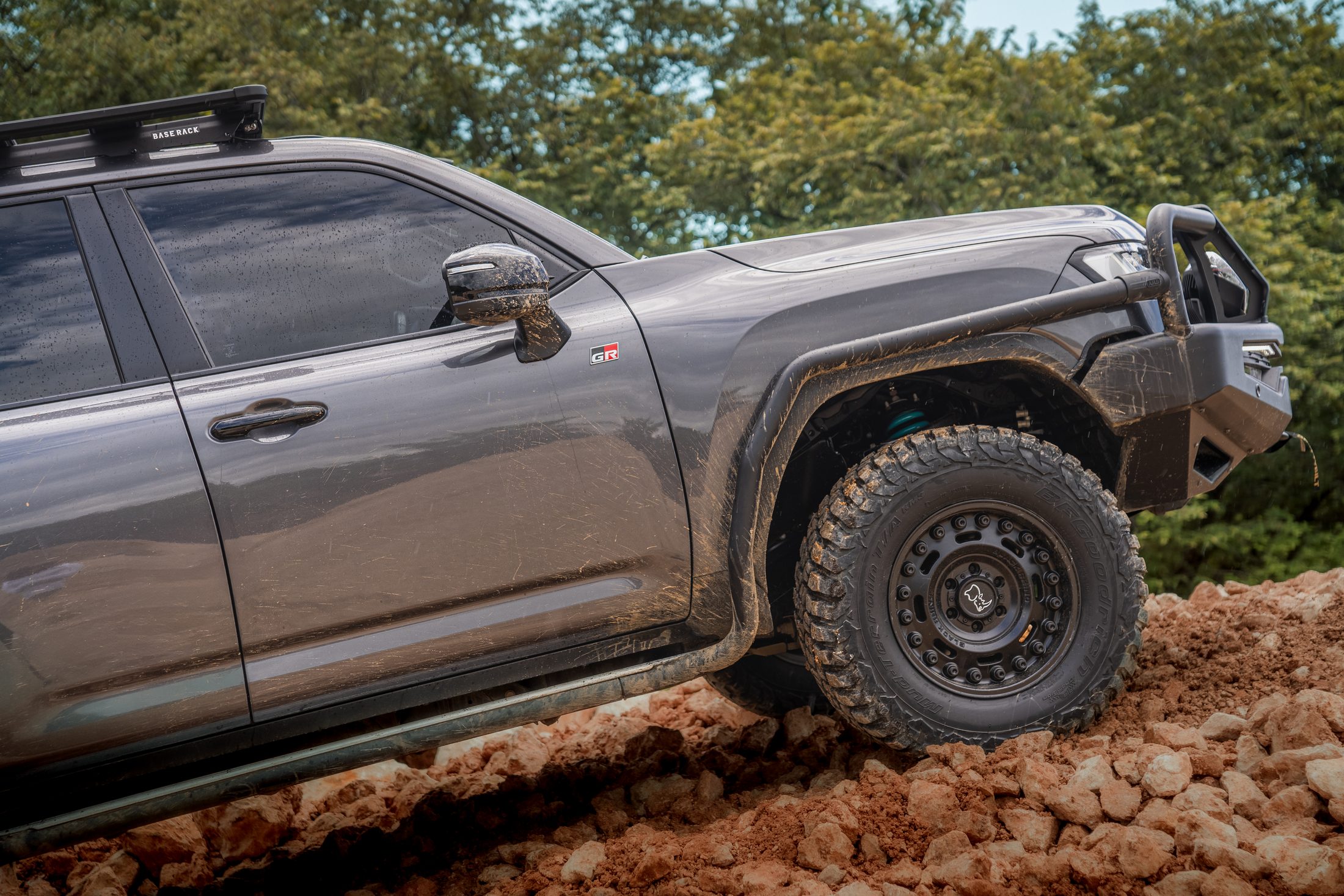 Toyota Land Cruiser 300 front wheel climbing red rocks, photographed by Maxime Hugo